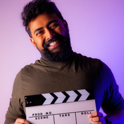 Smiling Bearded Man with Clapperboard