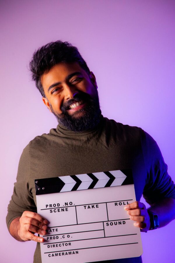 Smiling Bearded Man with Clapperboard